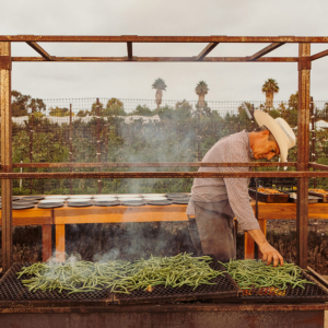 Chef David Pratt grilling green beans for the Community Table at The Ecology Center