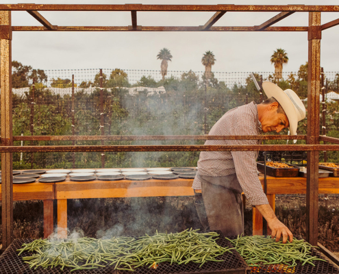 Chef David Pratt grilling green beans for the Community Table at The Ecology Center